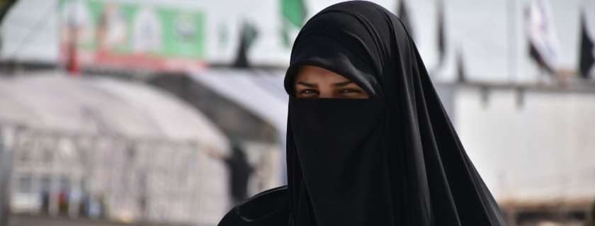 woman covered in black scarf and yemen people